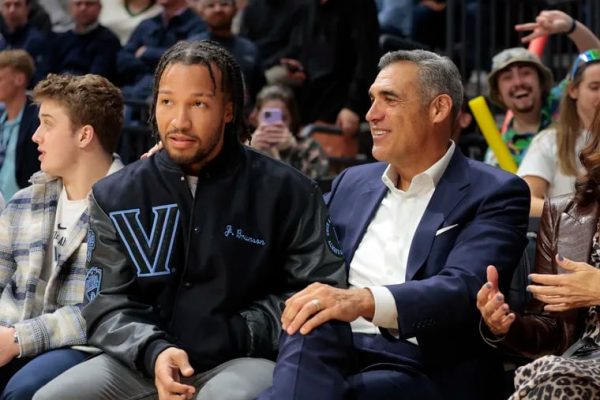 Last year Villanova retired the number of Jalen Brunson (left), seen here sitting beside former coach Jay Wright.