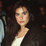 1985: Actress Demi Moore shown standing, wearing a fringed, leather coat.